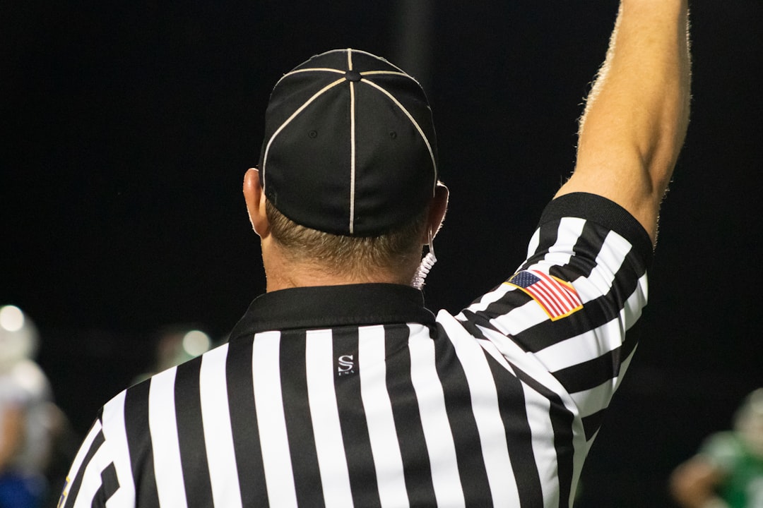 American Football Referee - Back of head and shoulders - Right Arm Raised