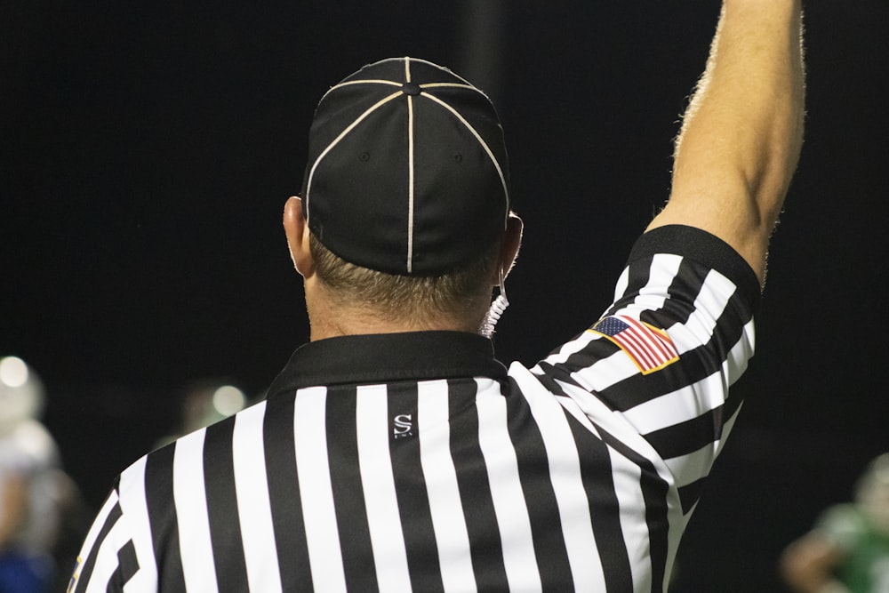 a referee in a black and white striped uniform