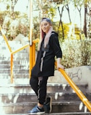 a woman with pink hair is standing on some stairs