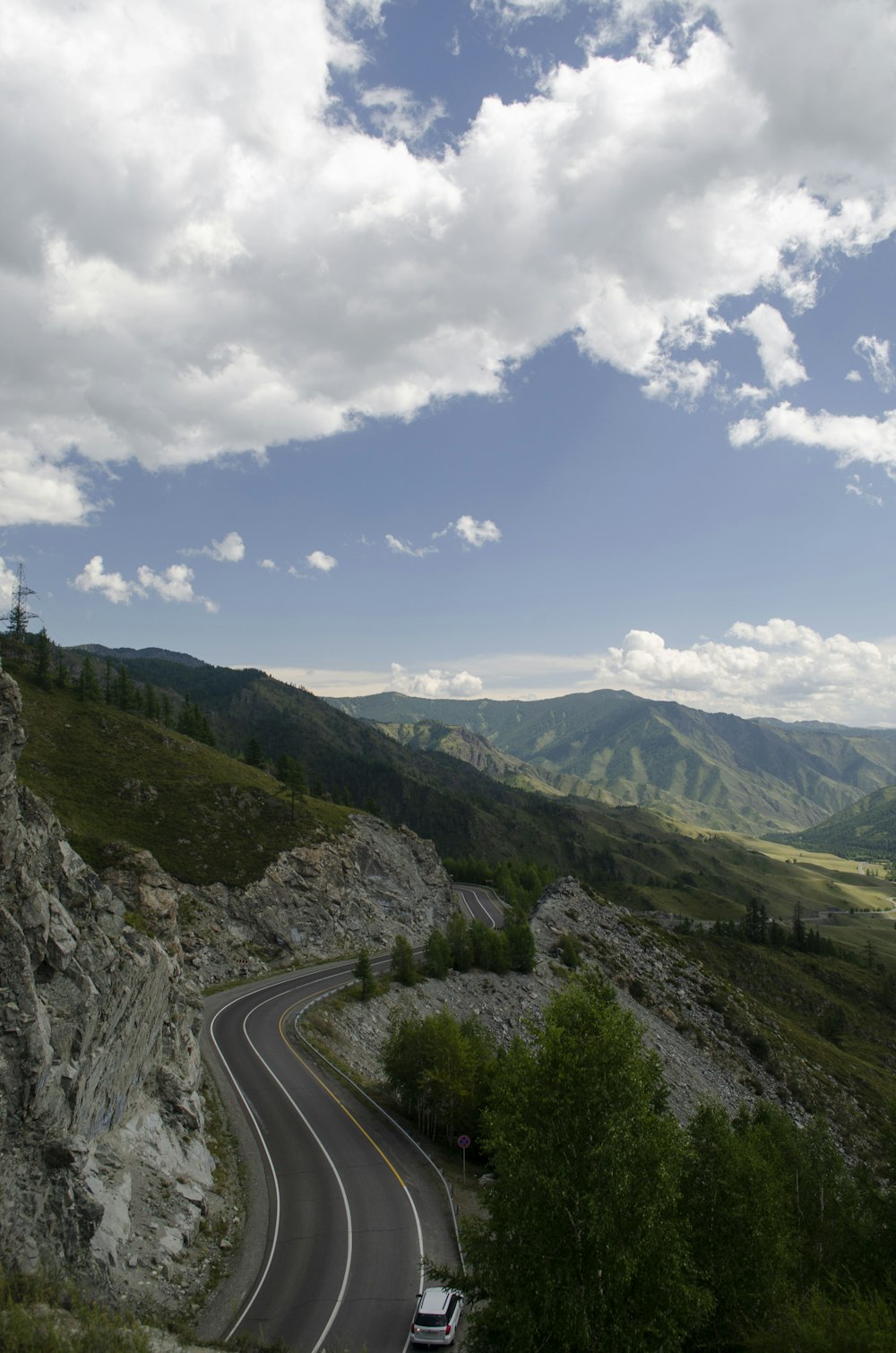 a car driving down a winding road in the mountains