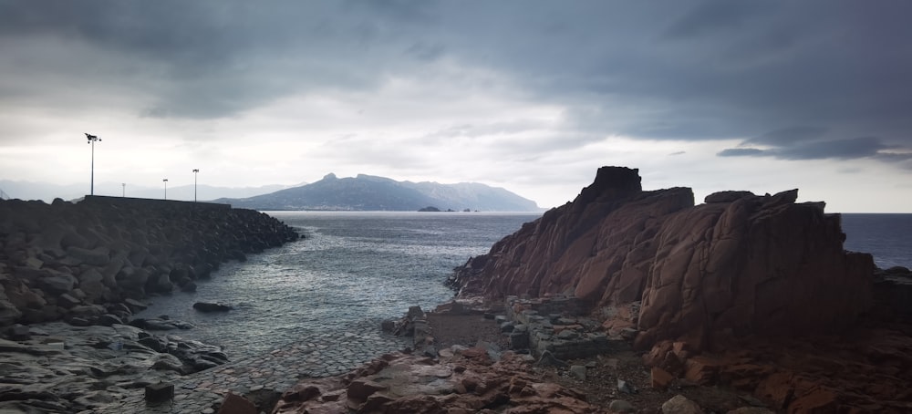 Una vista de una costa rocosa con una montaña en la distancia