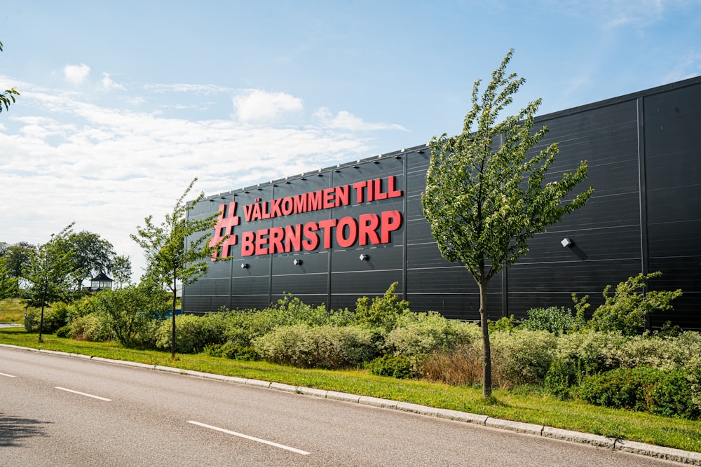 a large black building with a red sign on it