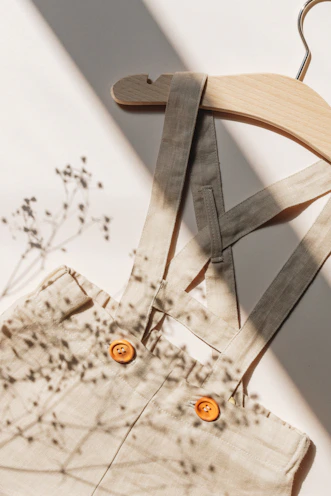 A charming set outfit displayed on a wooden hanger with soft natural light.