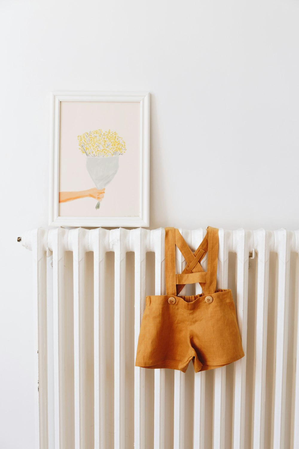 les vêtements d’un bébé accrochés à un radiateur