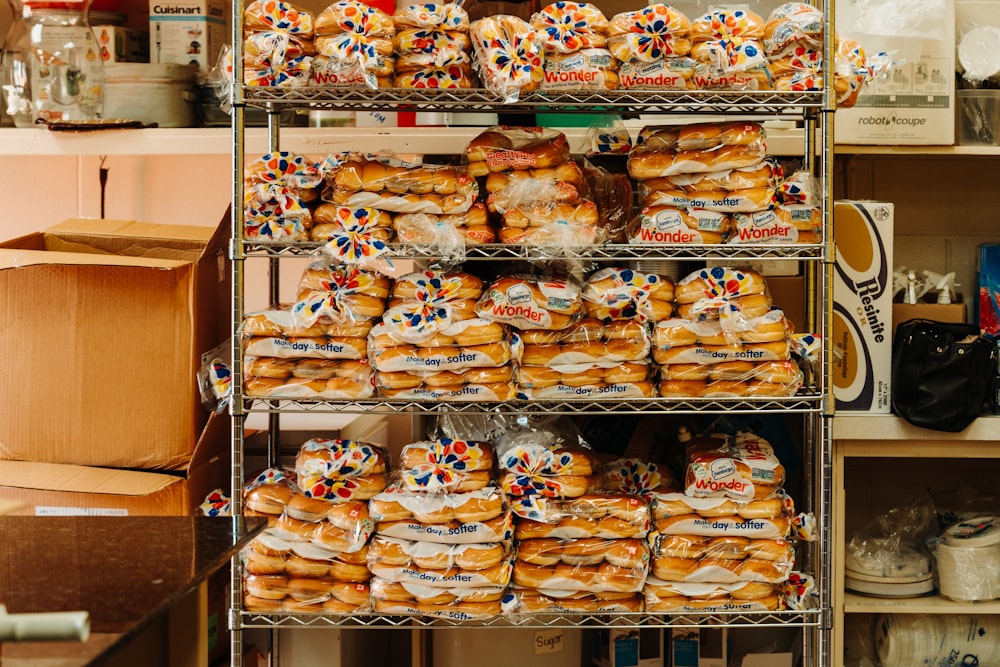a shelf filled with lots of different kinds of bread