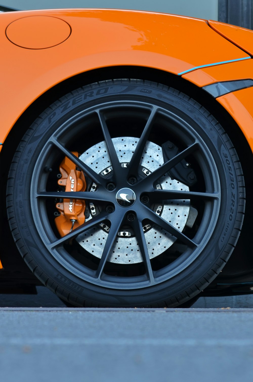 a close up of the front wheel of a sports car