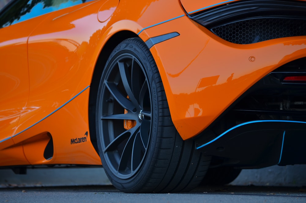 an orange sports car parked in a garage