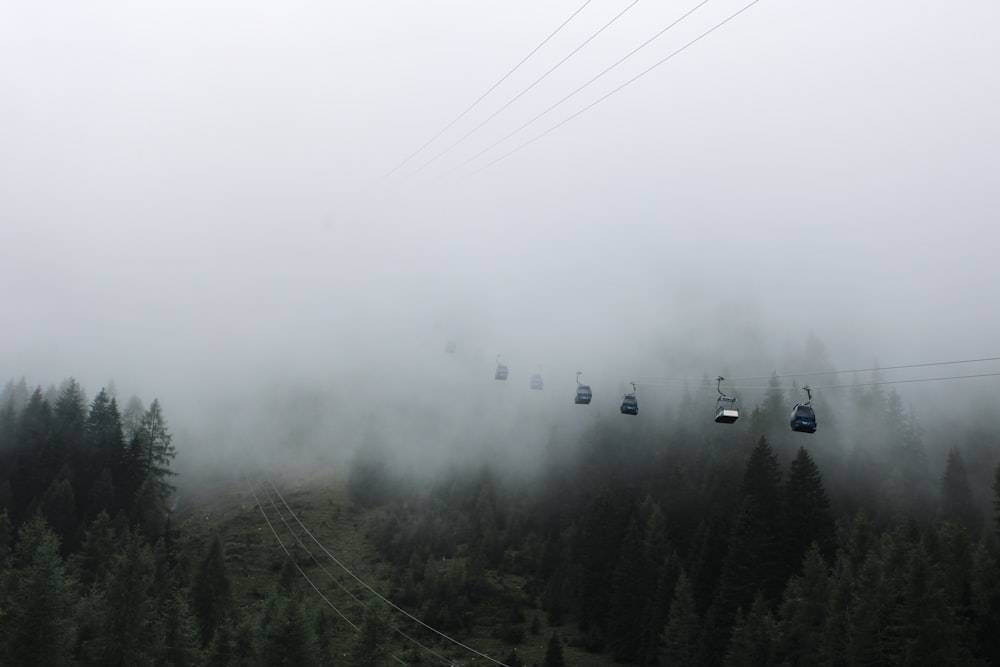 a foggy mountain with a ski lift in the distance