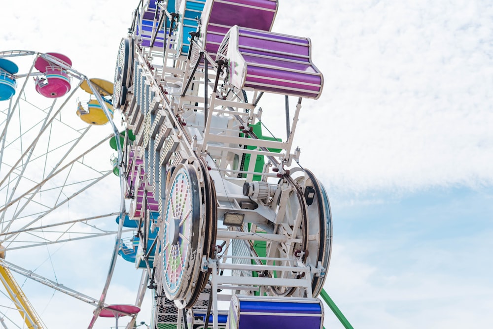 a colorful ferris wheel with a blue sky in the background