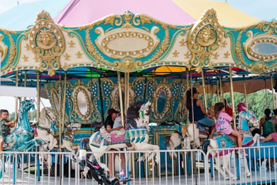 a group of people riding on top of a carousel