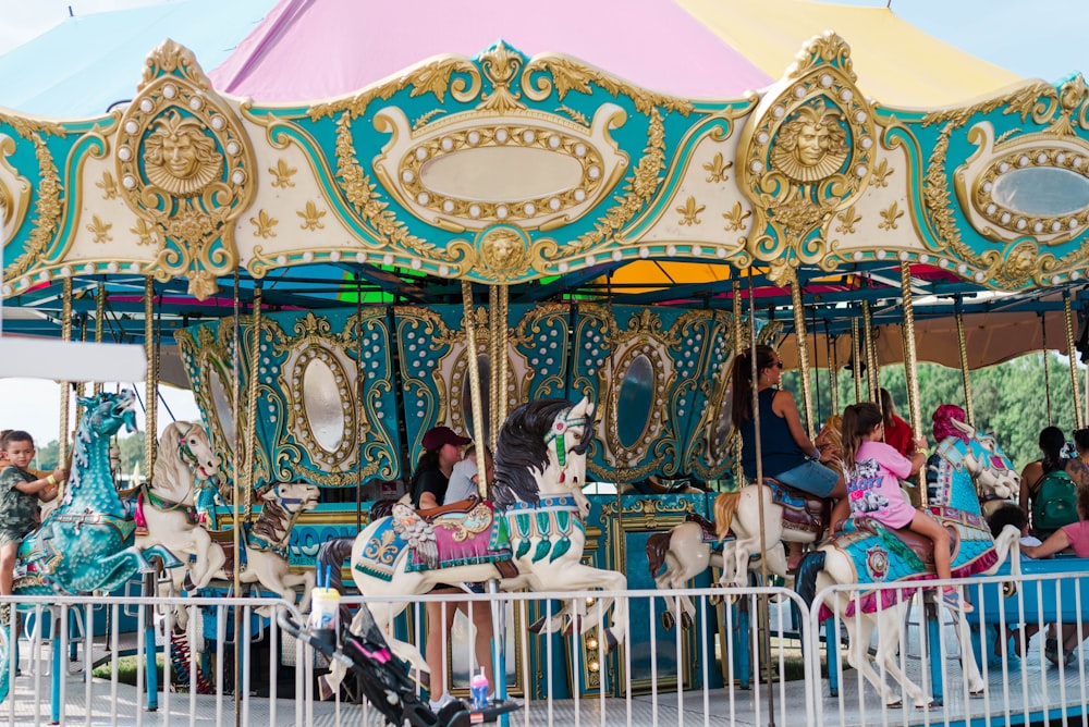 a group of people riding on top of a carousel