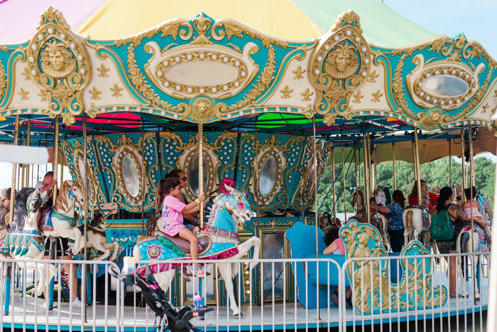 a group of people riding on top of a merry go round