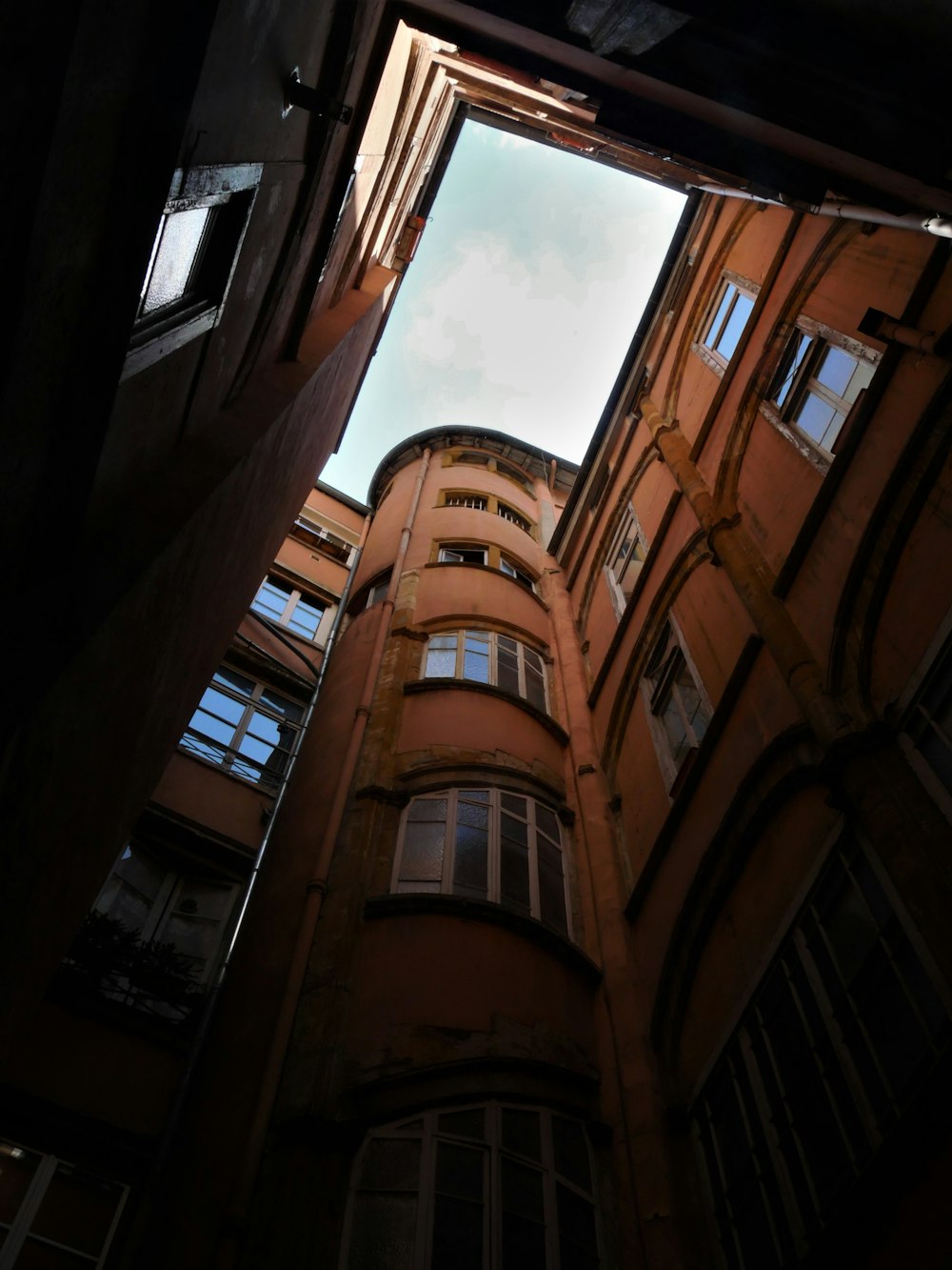 looking up at a tall building with windows