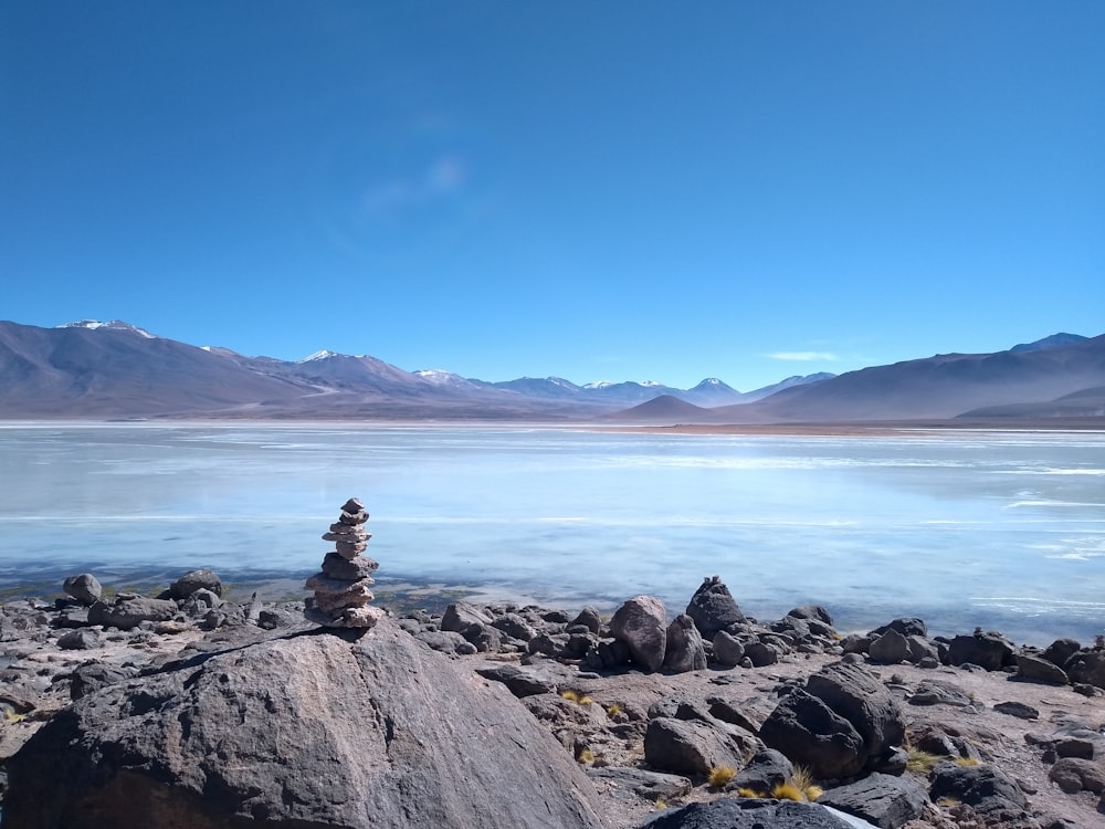 a pile of rocks sitting on top of a lake