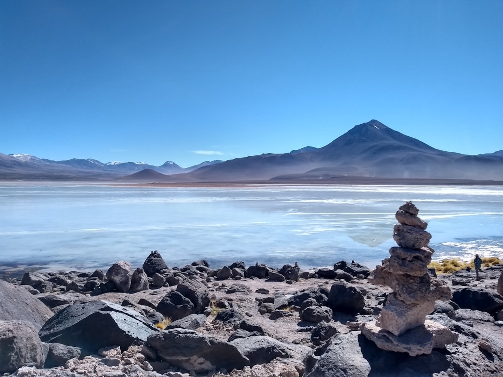 a stack of rocks sitting on top of a rocky beach