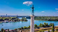 a statue of a man standing on top of a tower