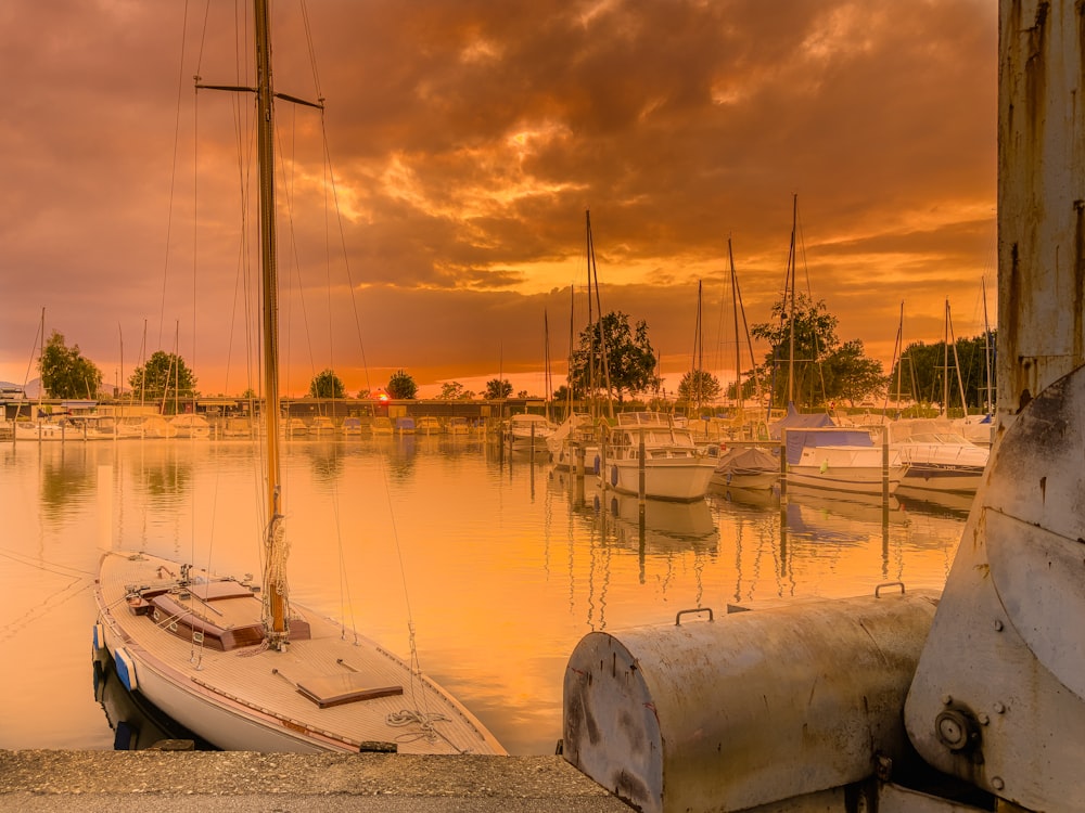 a sailboat sits in the water at sunset
