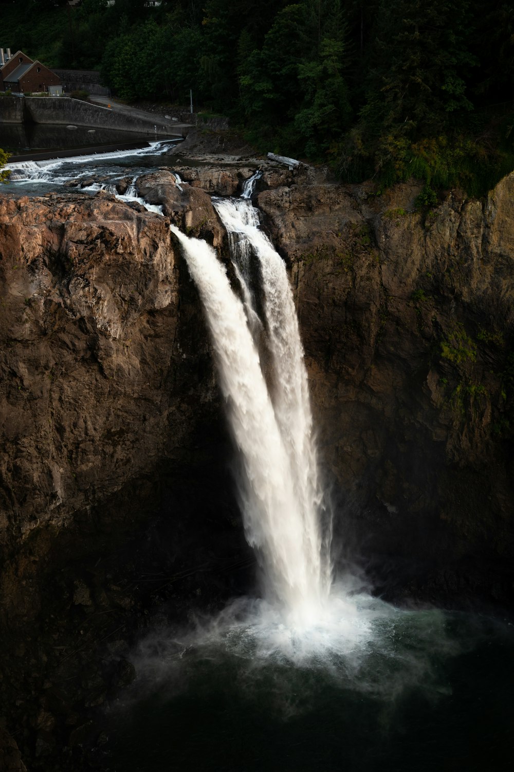 a large waterfall with water cascading down it's sides