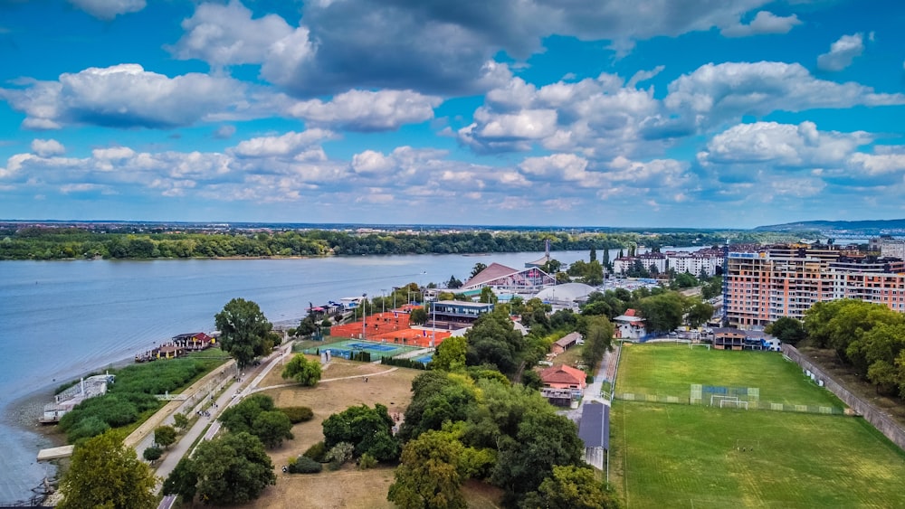 an aerial view of a city with a lake in the background