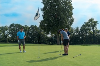 a group of people playing a game of golf