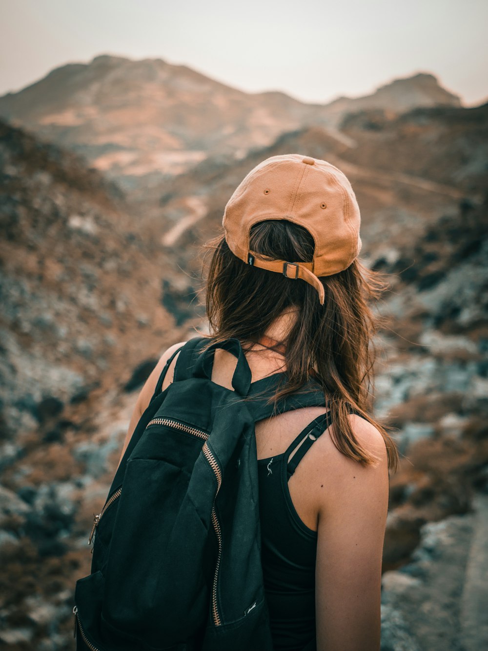a person with a backpack and a hat on