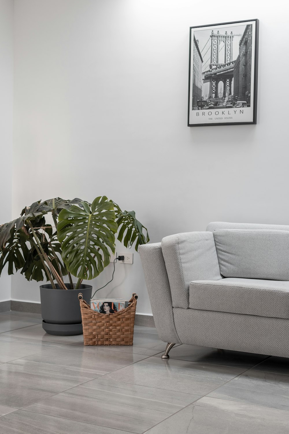 a living room with a couch and a potted plant