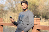 A person smiling peacefully while using the app outdoors in nature