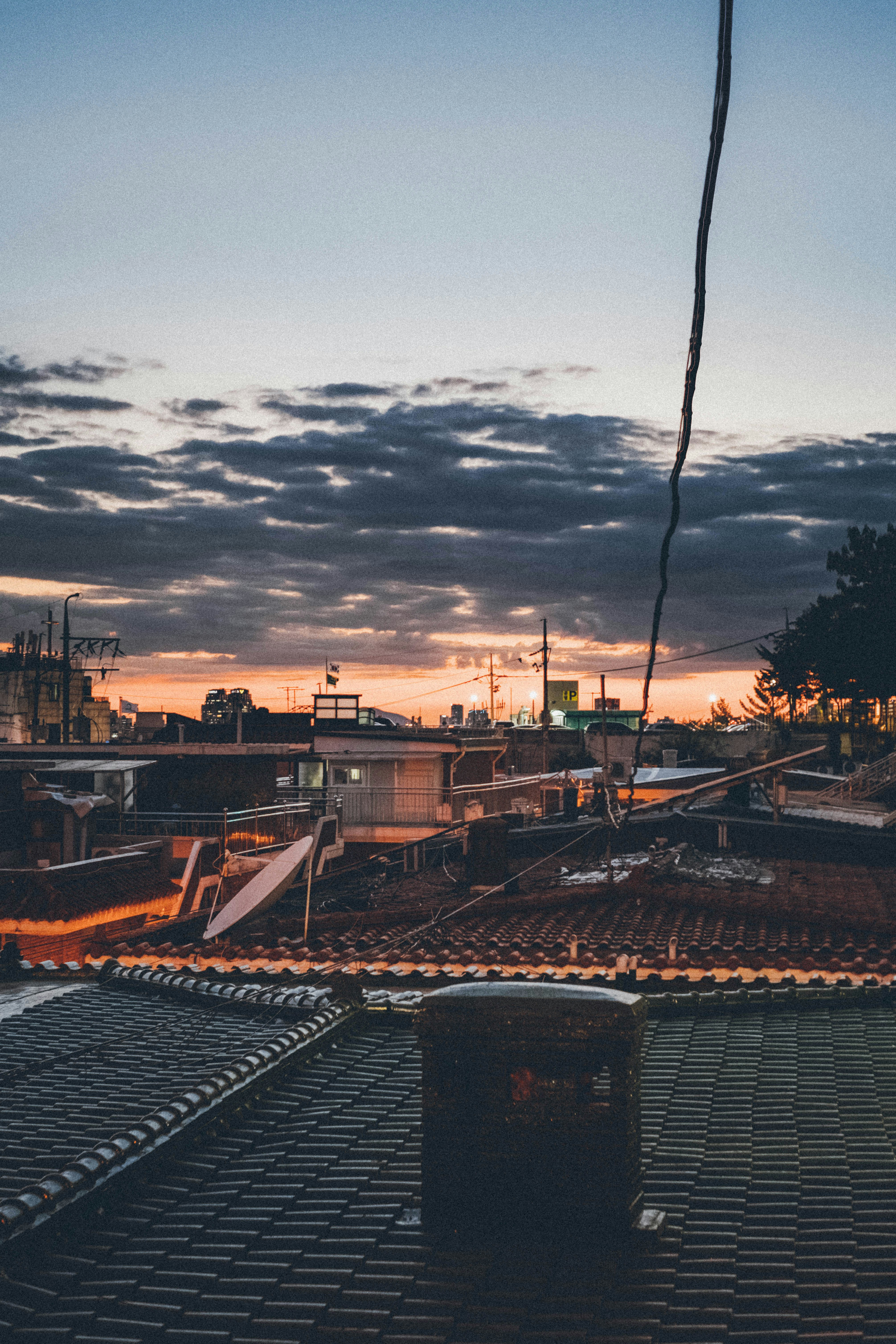 A view of a city from a rooftop at night photo – Free Water Image on ...