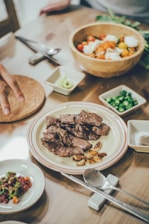 A beautifully arranged table featuring a variety of grilled dishes and colorful side salads.