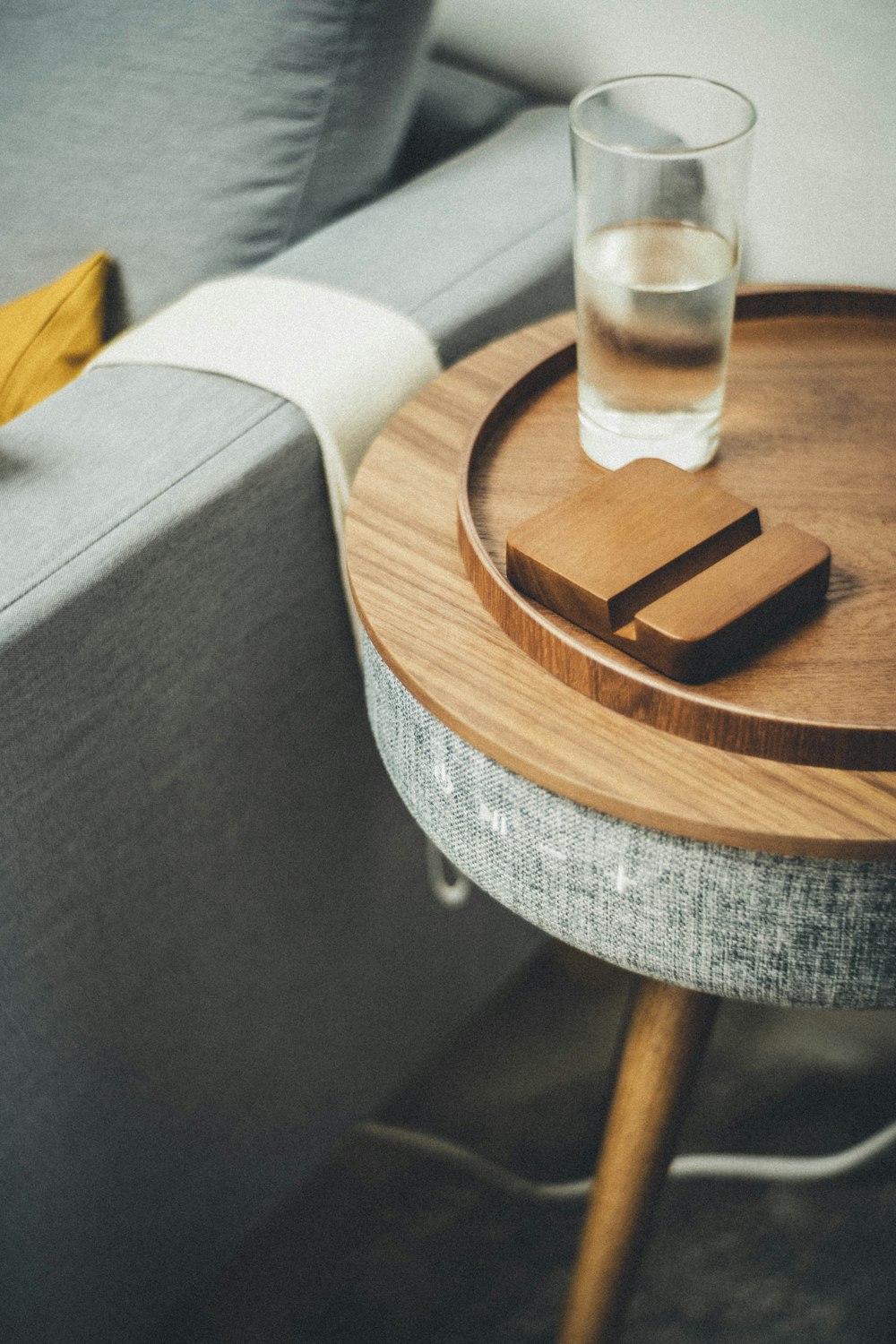 a glass of water sitting on top of a wooden table