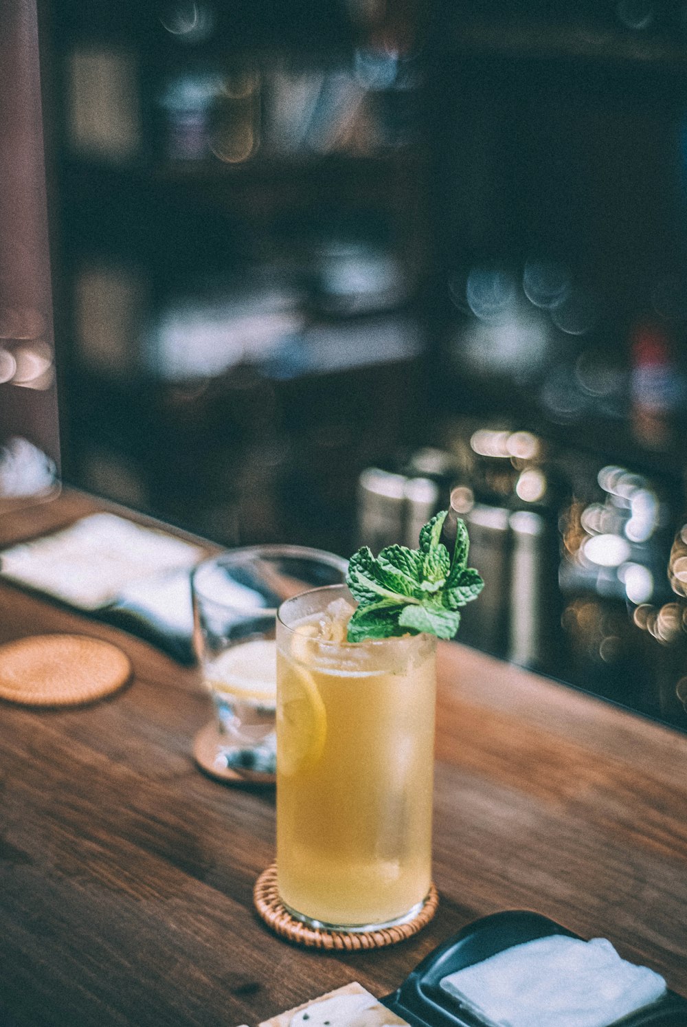 a glass of lemonade sitting on top of a wooden table