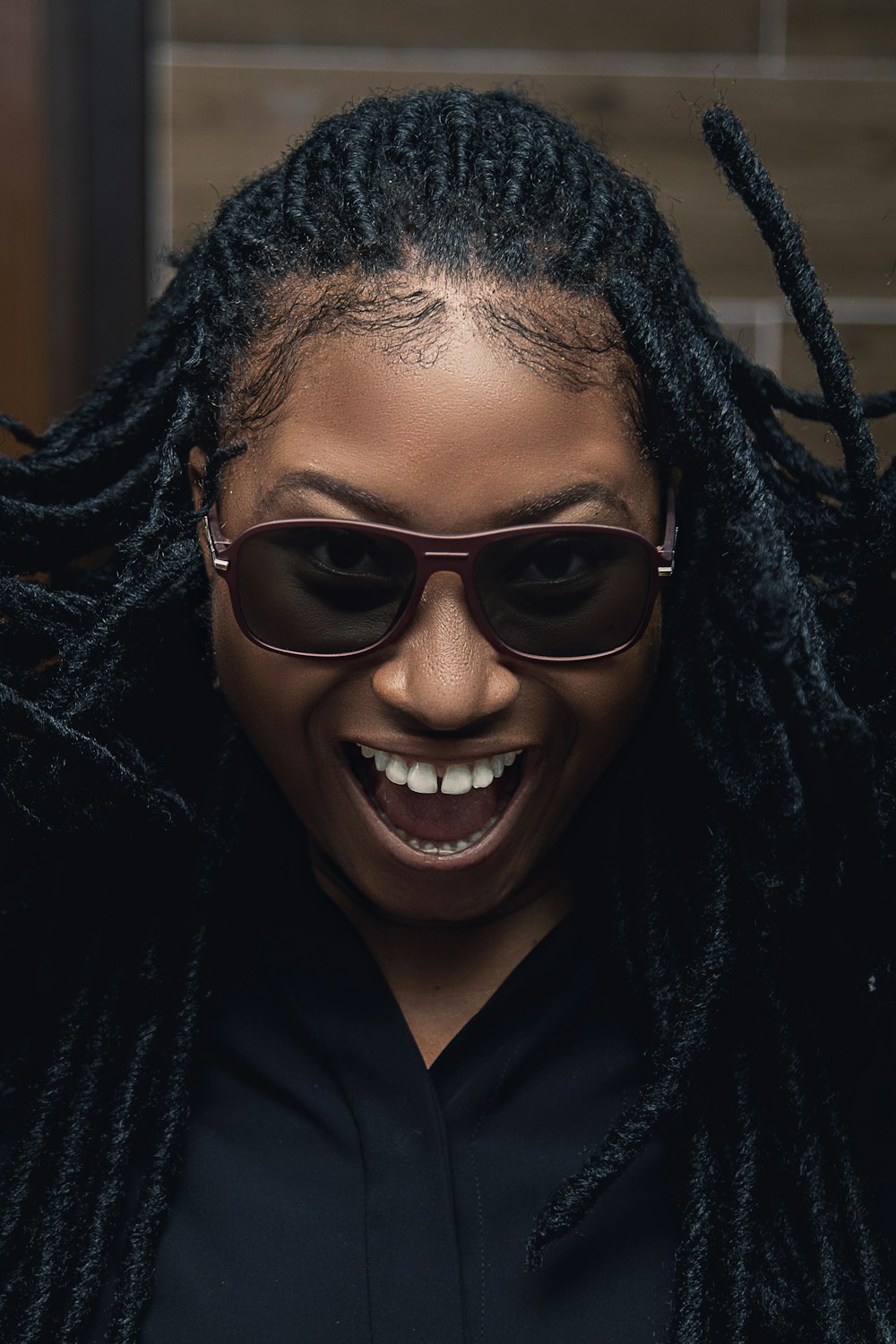 a woman with dreadlocks and a black shirt