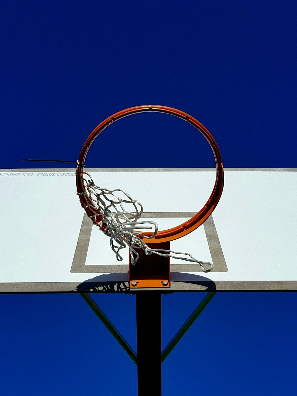 a basketball going through the hoop of a basketball court