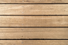 a close up of a wooden surface with nails