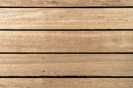 a close up of a wooden surface with nails