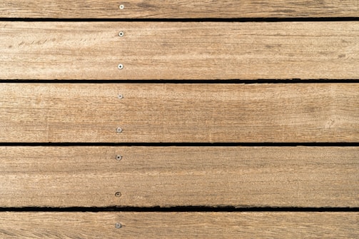a close up of a wooden surface with nails