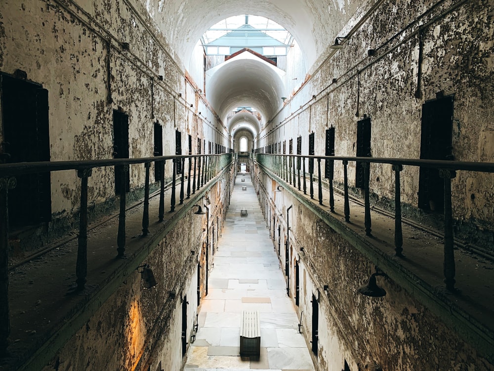 a long tunnel with a metal railing leading up to it