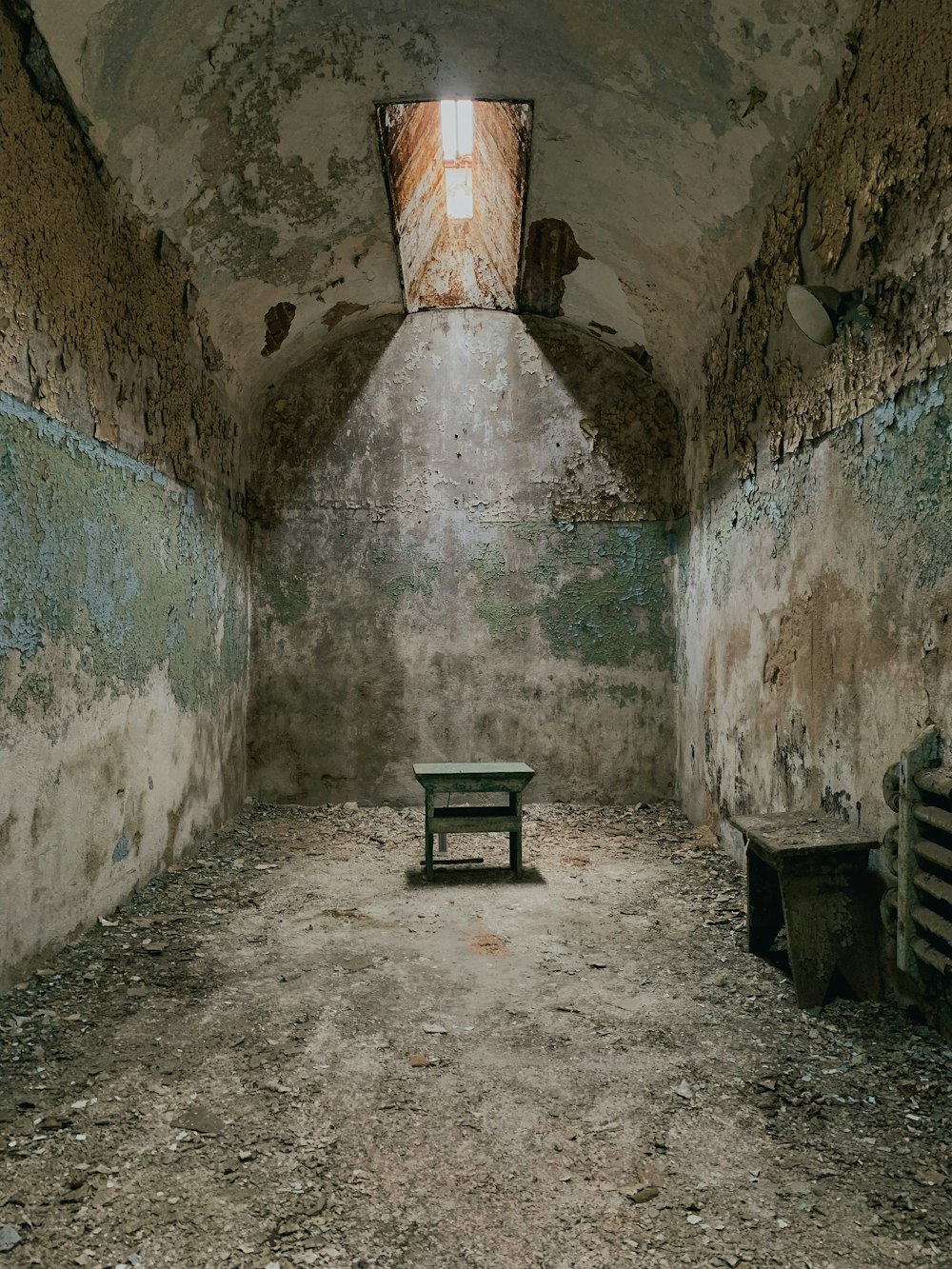 a small bench in a very old looking room