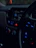 Interior shot of a car dashboard with high-tech audio equipment illuminated by blue neon lights.