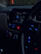 Interior shot of a car dashboard with high-tech audio equipment illuminated by blue neon lights.