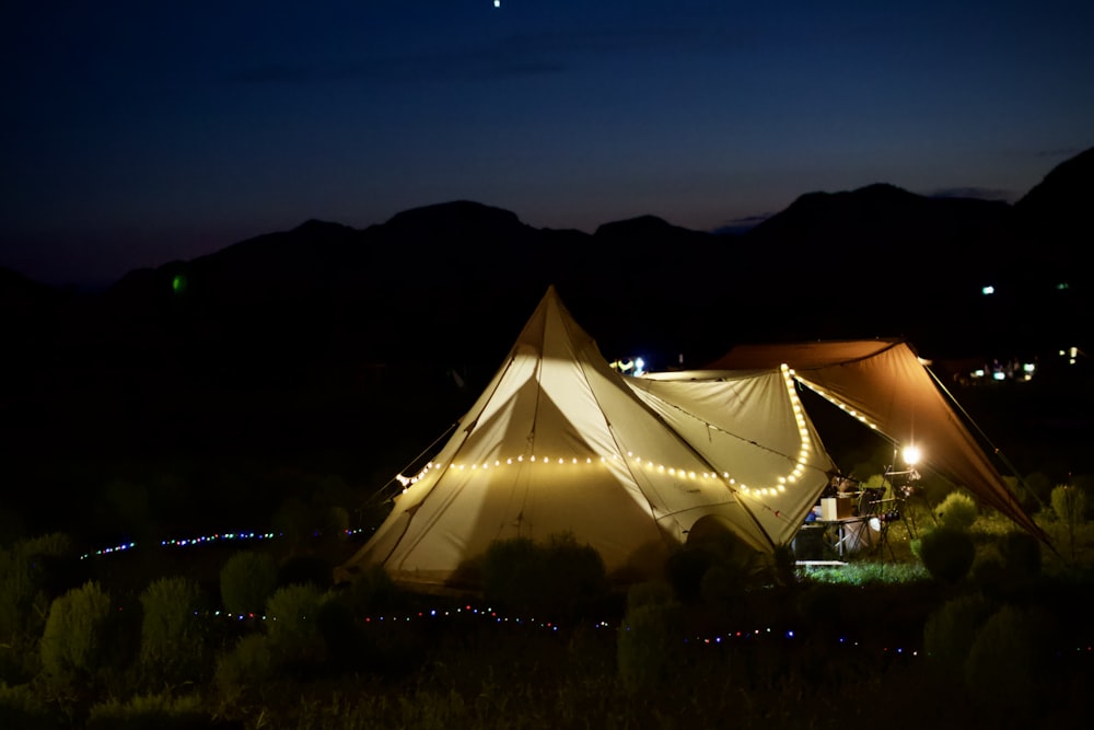 a large tent with a string of lights on it