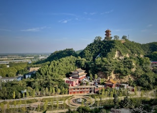 an aerial view of a building on a hill