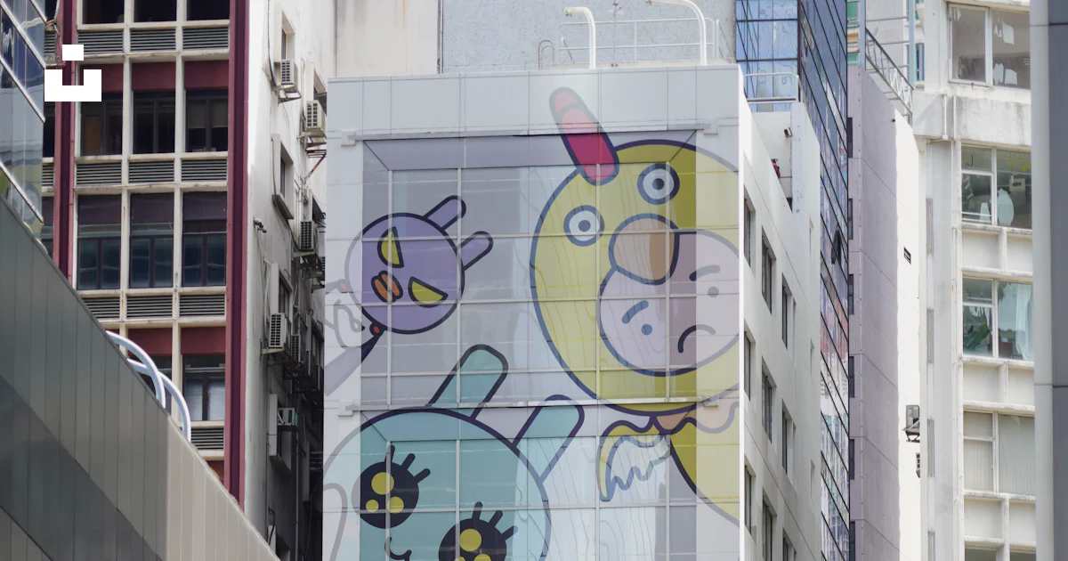A tall building with a mural on the side of it photo – Free Art Image ...