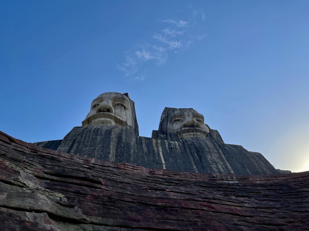 zwei große Statuen von Köpfen auf einem Berg