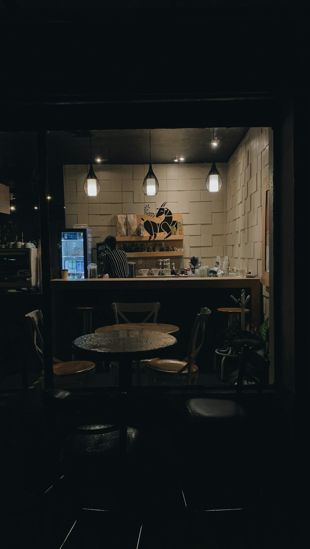 a dimly lit room with a table and chairs