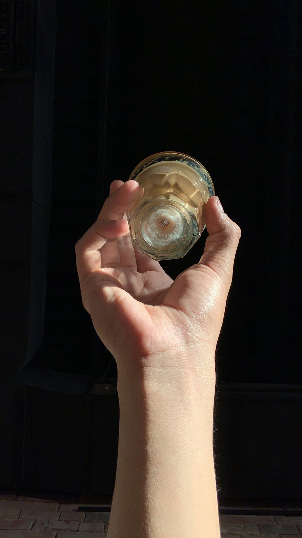 a person holding a wine glass in their hand