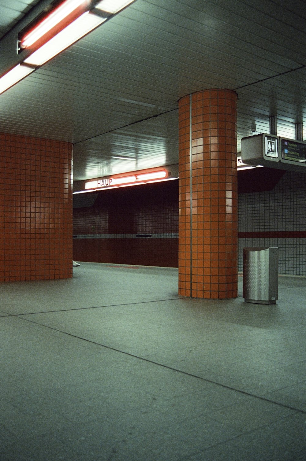 an empty parking garage with orange brick walls