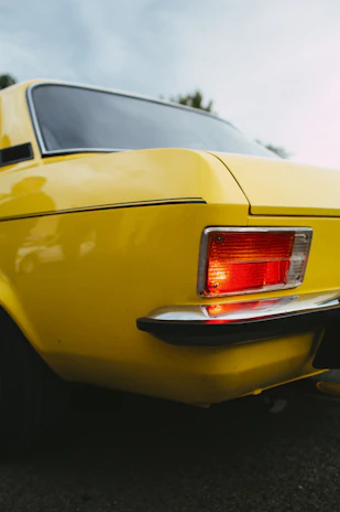 a close up of the tail lights of a yellow car