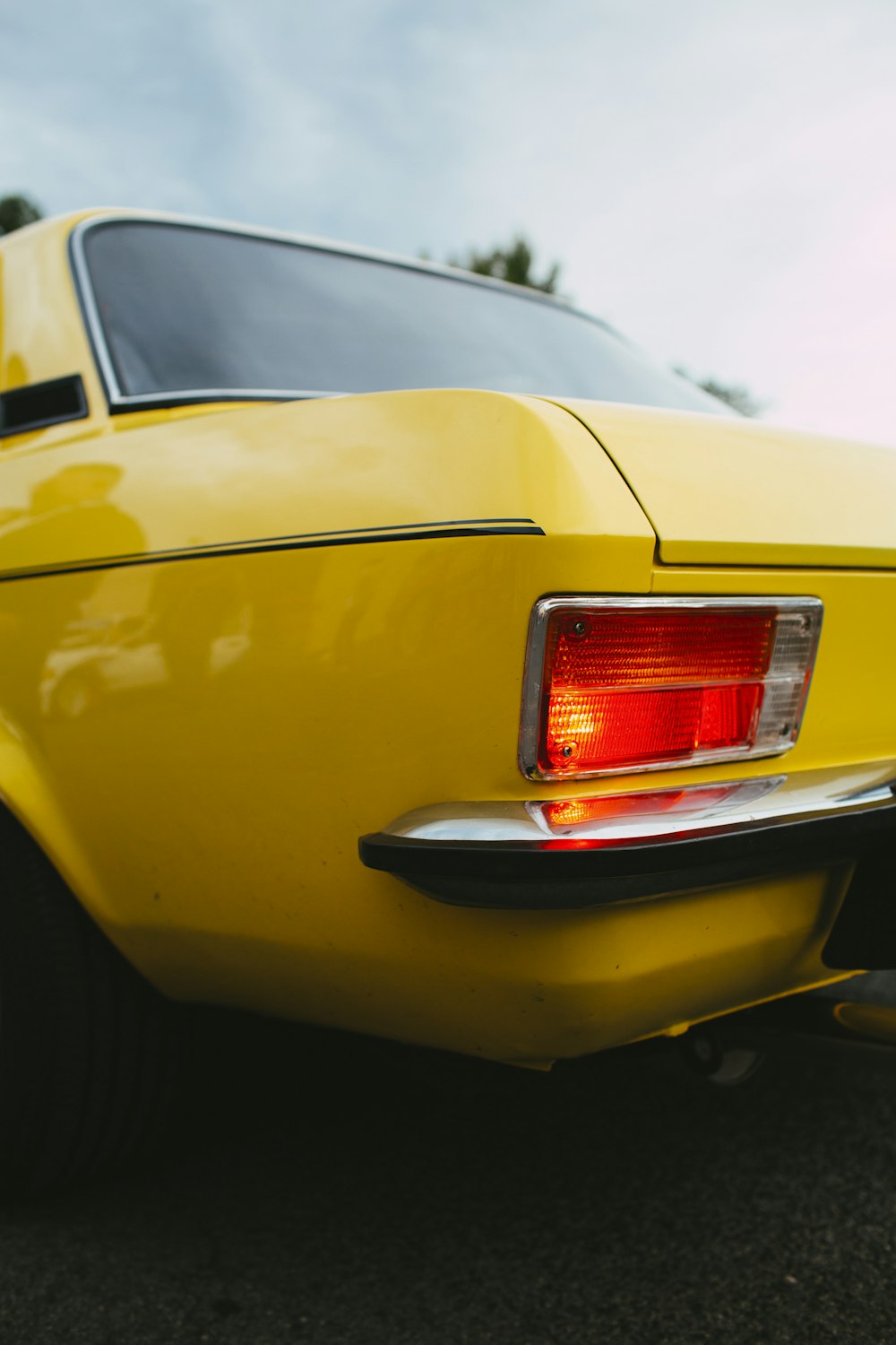 a close up of the tail lights of a yellow car
