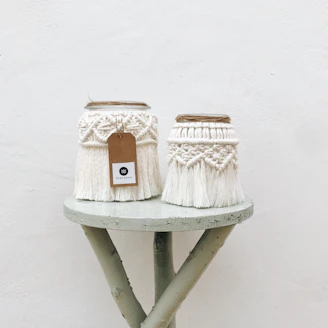 Minimalist macrame coasters arranged neatly on a wooden table with soft natural light.